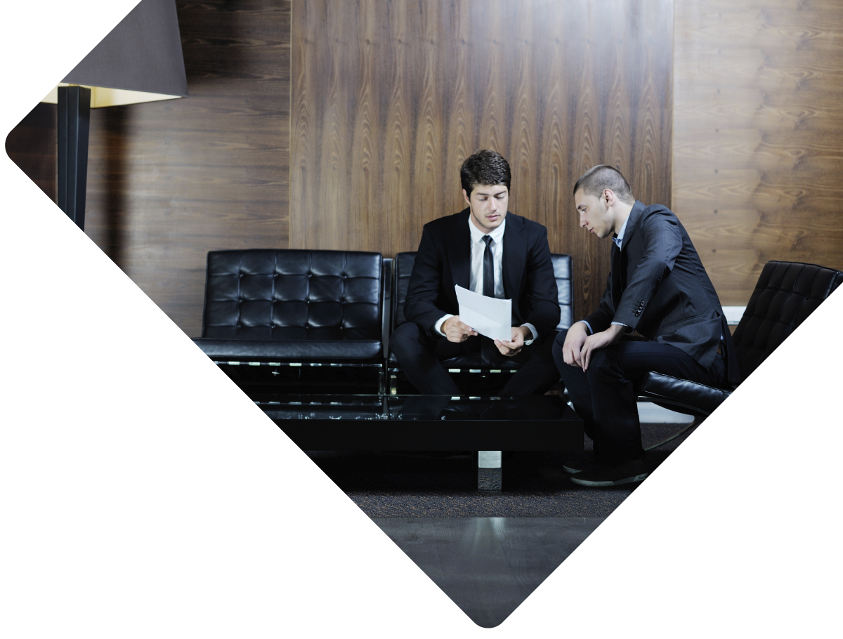 Executives in waiting room reviewing information.